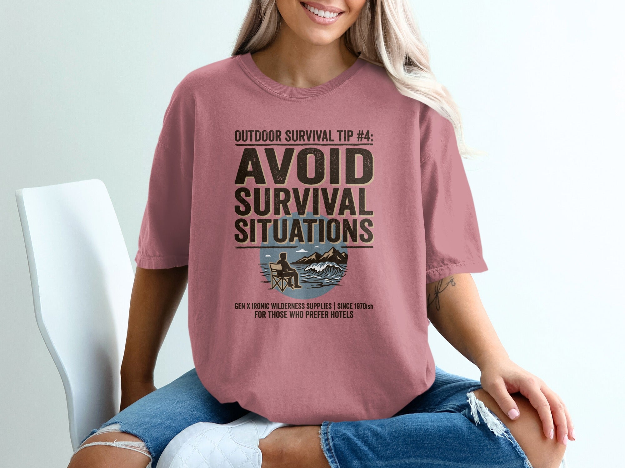 T-shirt with "Avoid Survival Situations" graphic and ironic wilderness slogan.