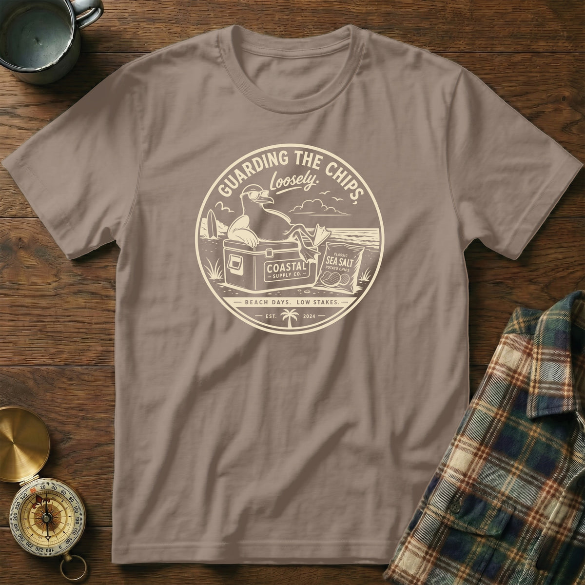 T-shirt with graphic of seagull guarding chips with text "Guarding The Chips Loosely".