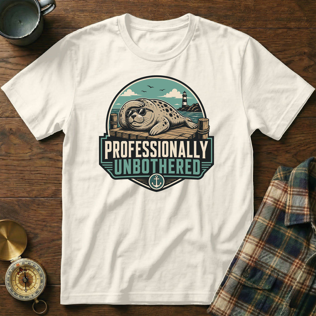 White t-shirt with a graphic of a seal in sunglasses and the text "PROFESSIONALLY UNBOTHERED".