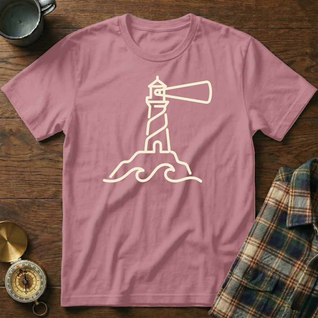 Pink t-shirt with a beige outline of a lighthouse and waves design.