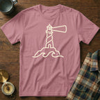 Pink t-shirt with a beige outline of a lighthouse and waves design.