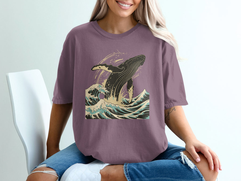 Purple t-shirt with whale breaching ocean waves graphic design.