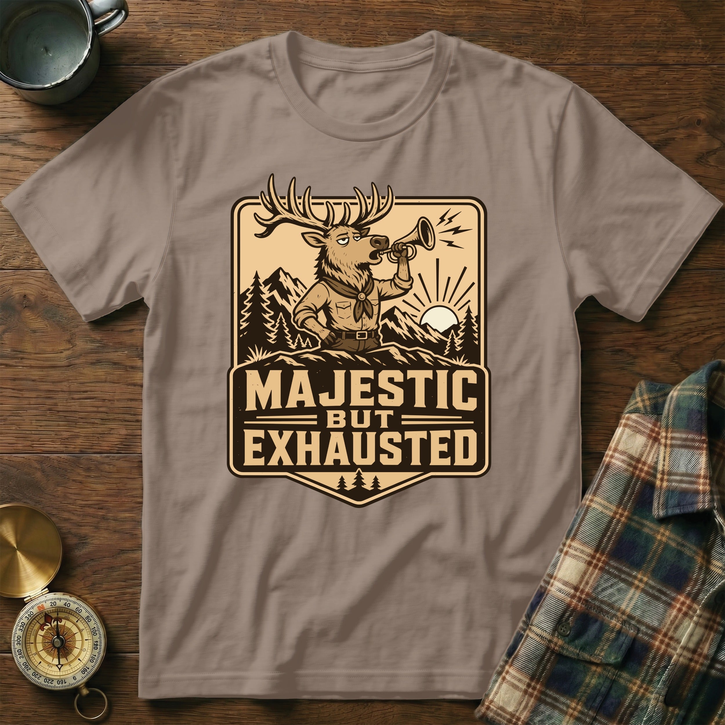 T-shirt with illustration of deer blowing horn, text "Majestic but Exhausted".
