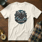 White t-shirt with a kraken and waves graphic that says "KRAKEN BEYOND THE DEPTHS."