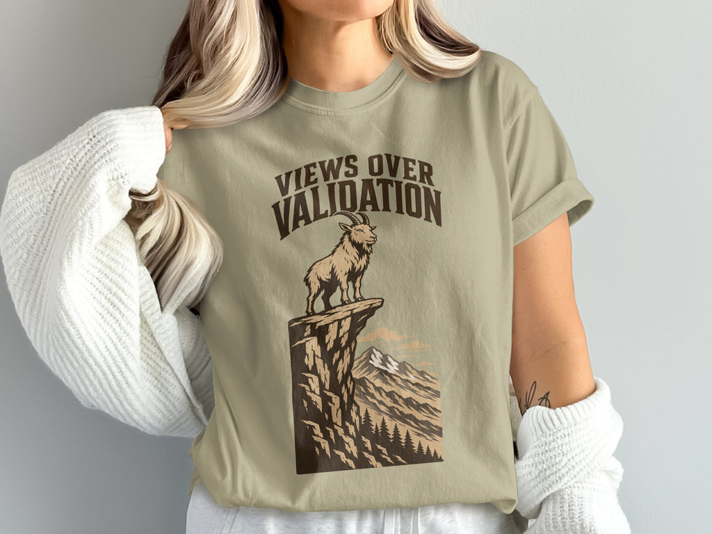 T-shirt graphic with goat on cliff and text "Views Over Validation."