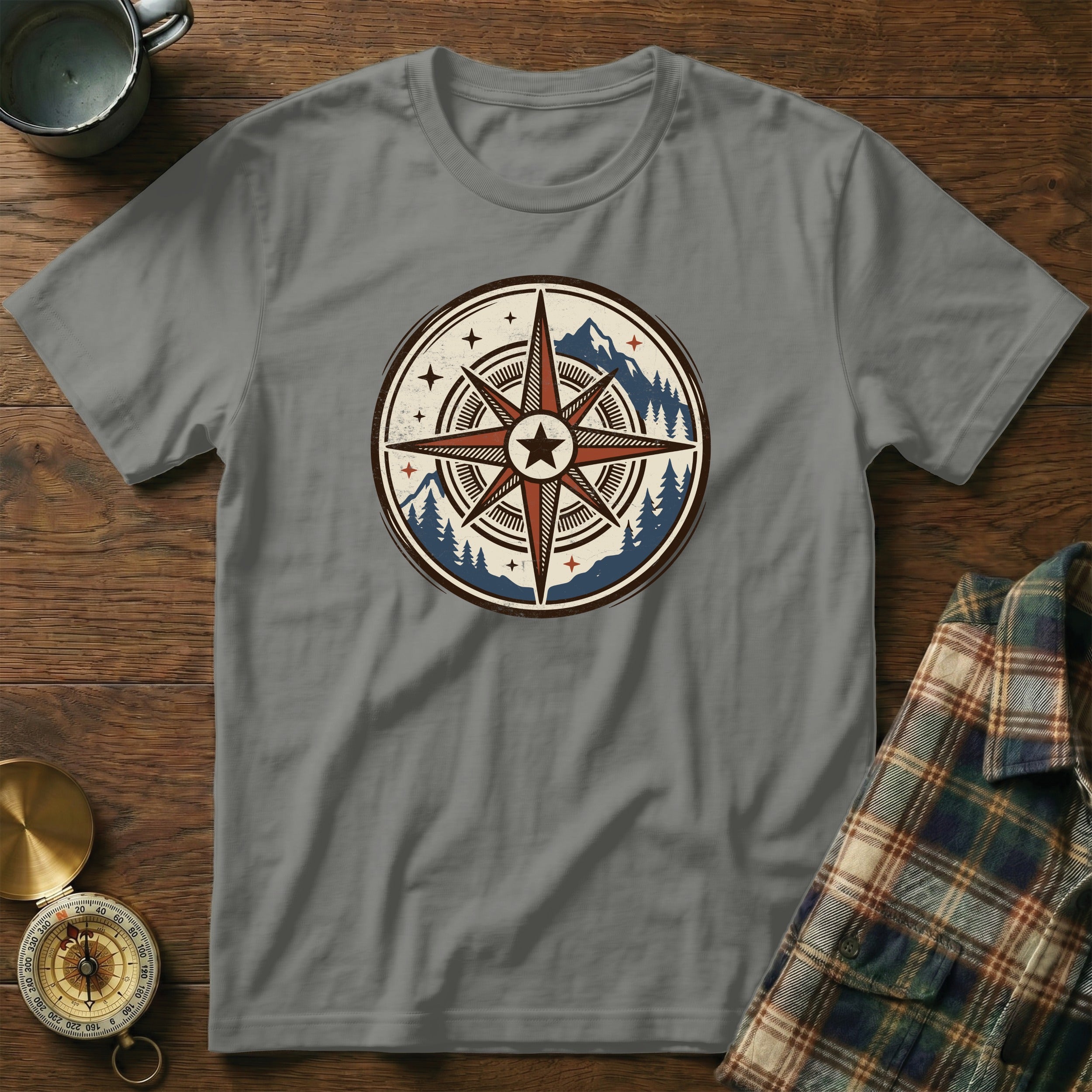 Gray t-shirt with a vintage compass graphic featuring mountains and trees.