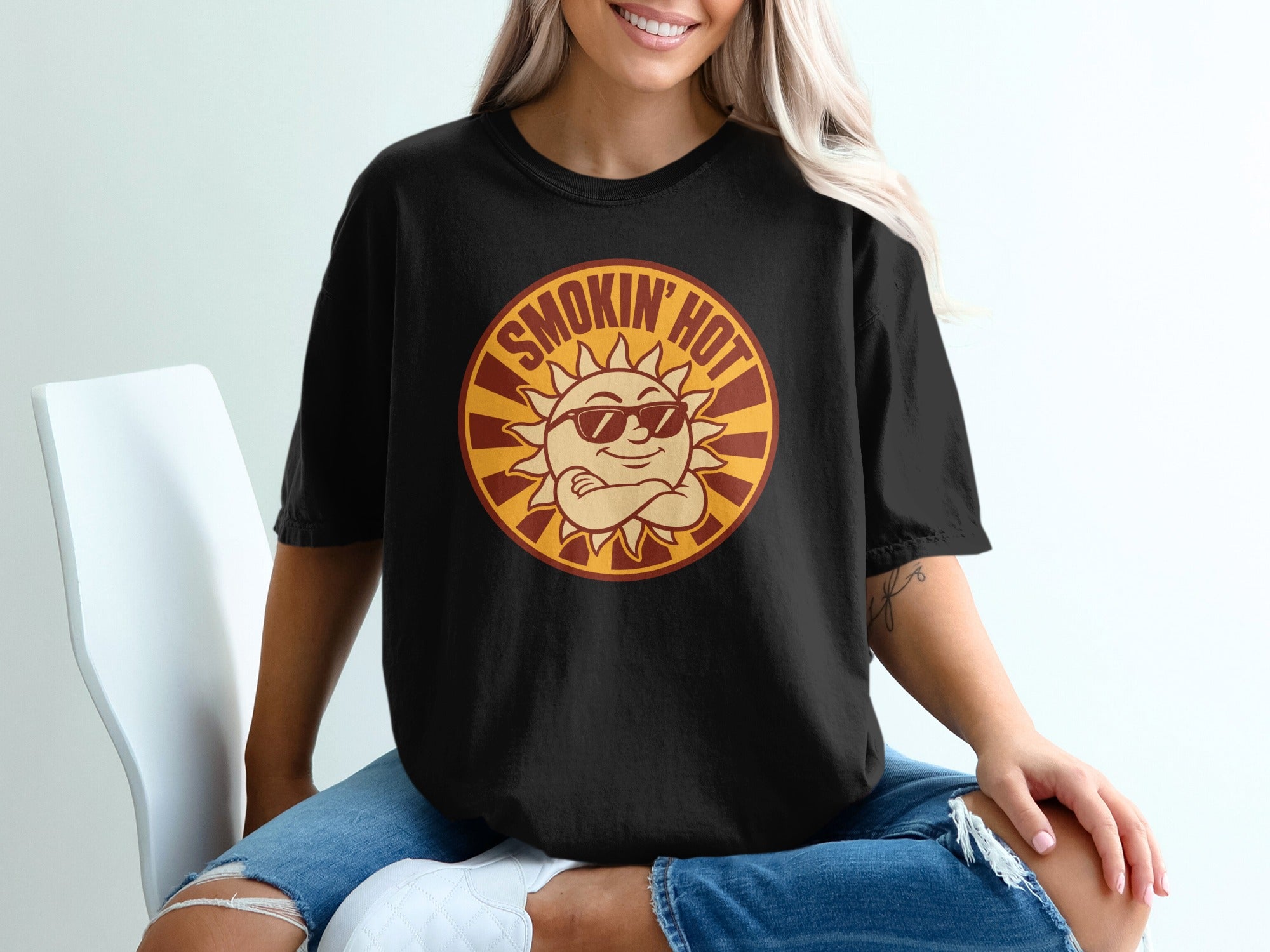 Black t-shirt with a cartoon sun wearing sunglasses and text "SMOKIN' HOT."