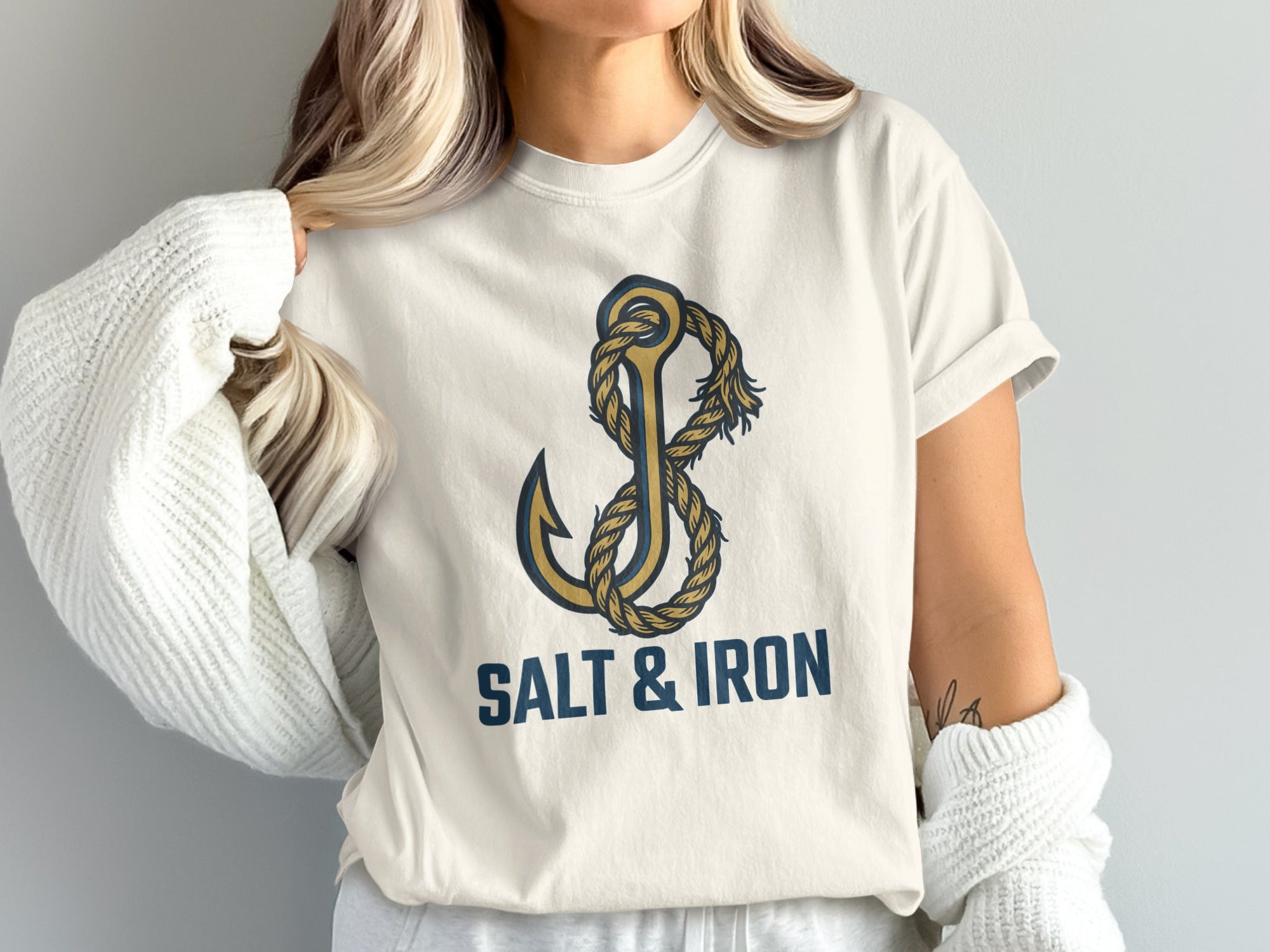 White t-shirt with gold anchor and rope graphic and "SALT & IRON" text.