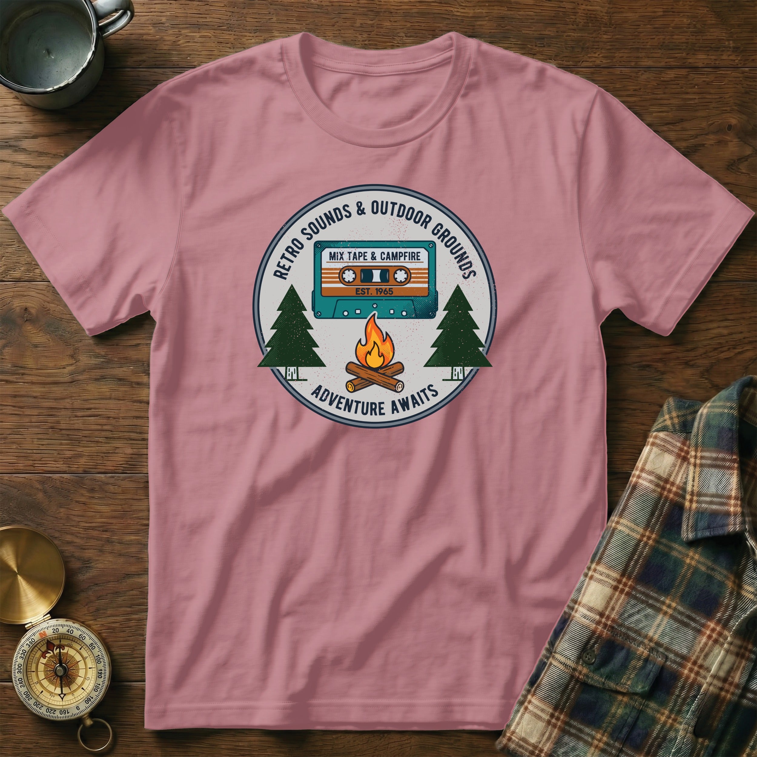 Pink t-shirt with a circular retro cassette tape and campfire graphic.
