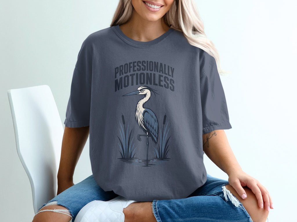 T-shirt with text professionally motionless and a heron standing in water.
