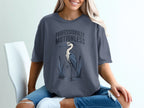 T-shirt with text professionally motionless and a heron standing in water.