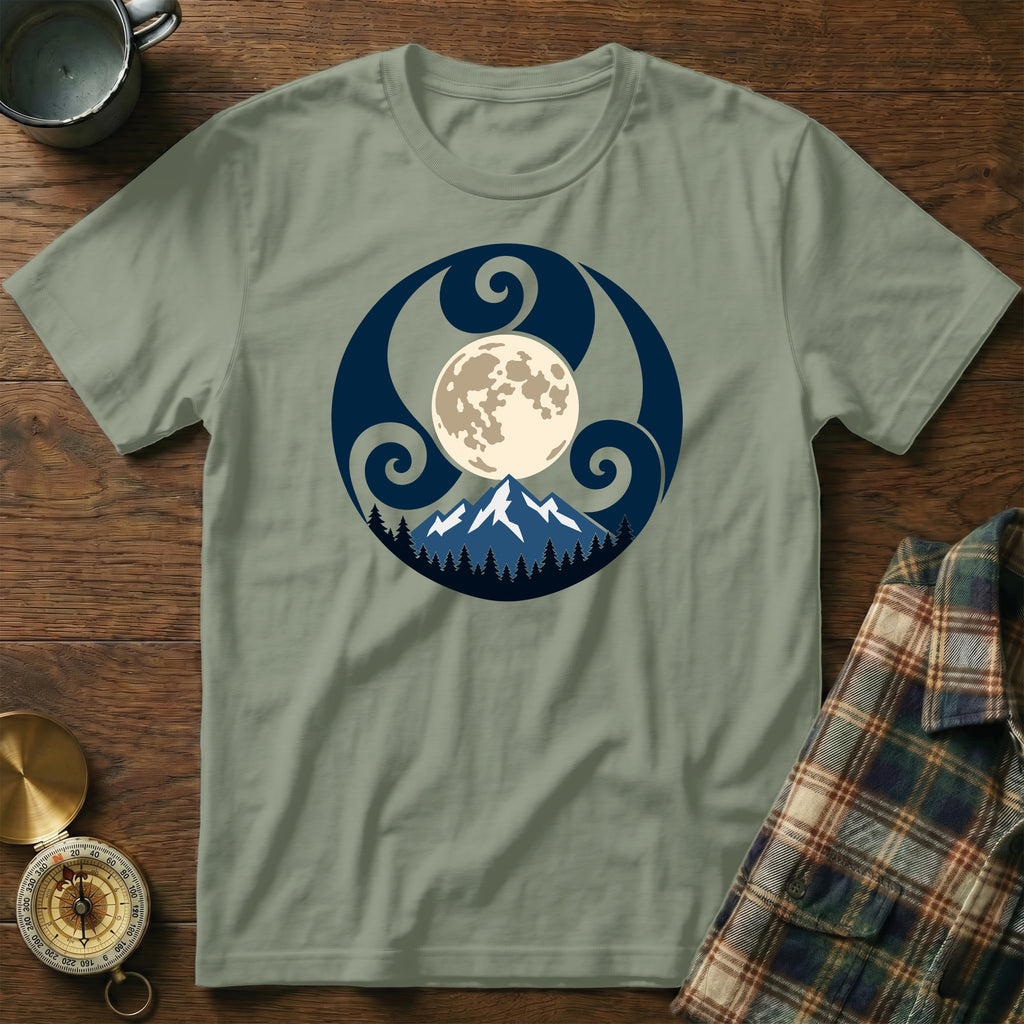 Green t-shirt with a circular design of a moon, mountains, and trees.