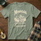Sage green t-shirt featuring a mountain and forest graphic with the text Mountain Sunrise hike Sunset arrival.