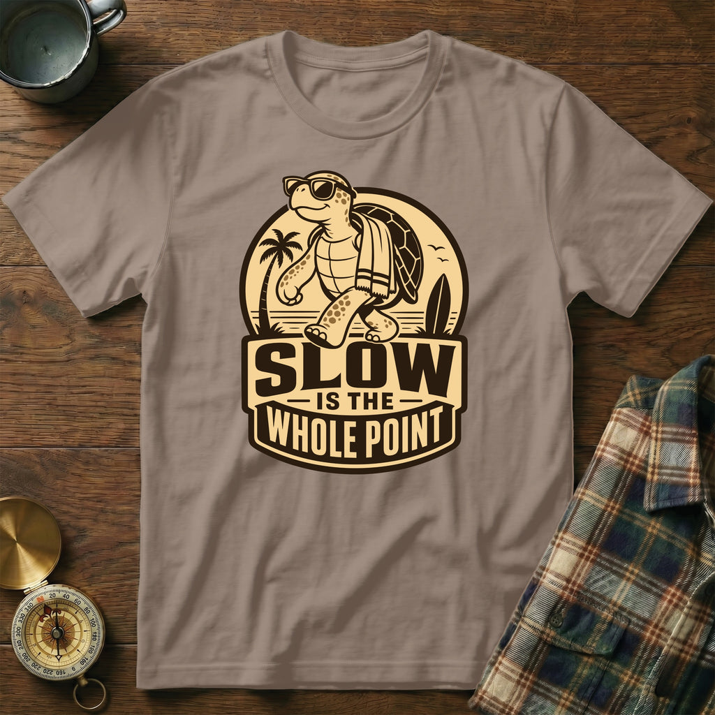 T-shirt with cartoon turtle, surfboard, palm trees, and text "SLOW IS THE WHOLE POINT".