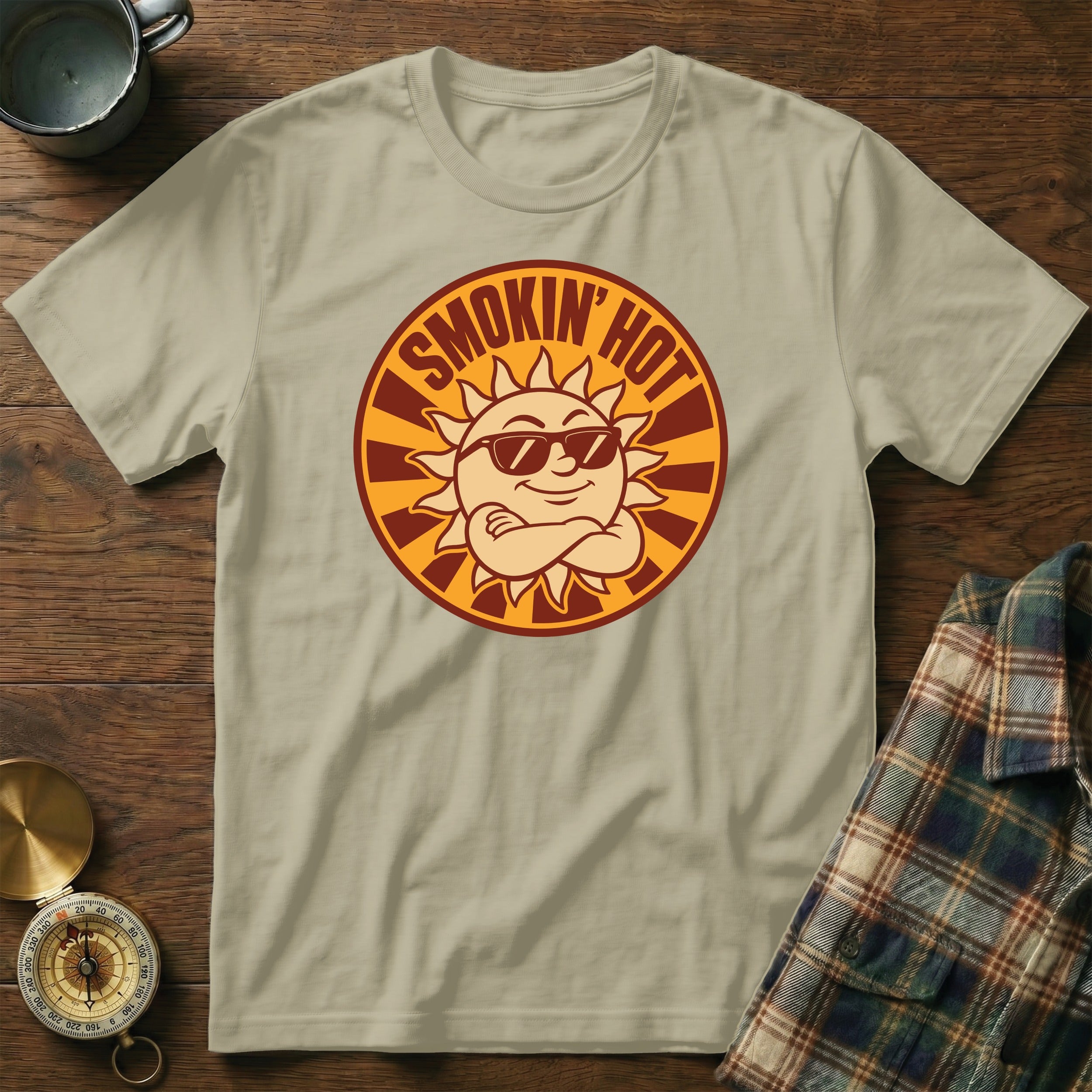 Light tan t-shirt with a circular graphic of a smiling sun wearing sunglasses.