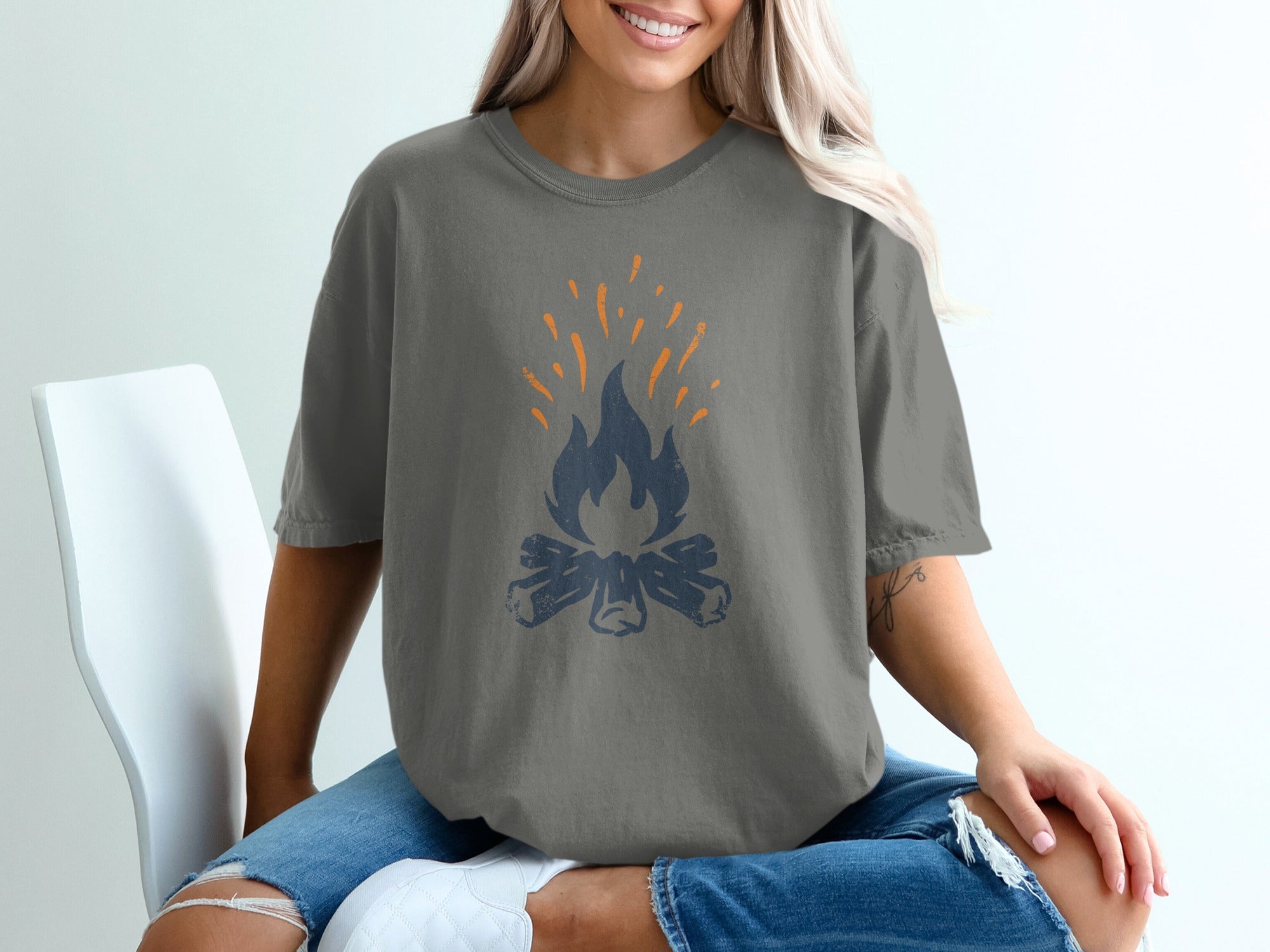 Gray t-shirt with a dark blue and orange campfire graphic.