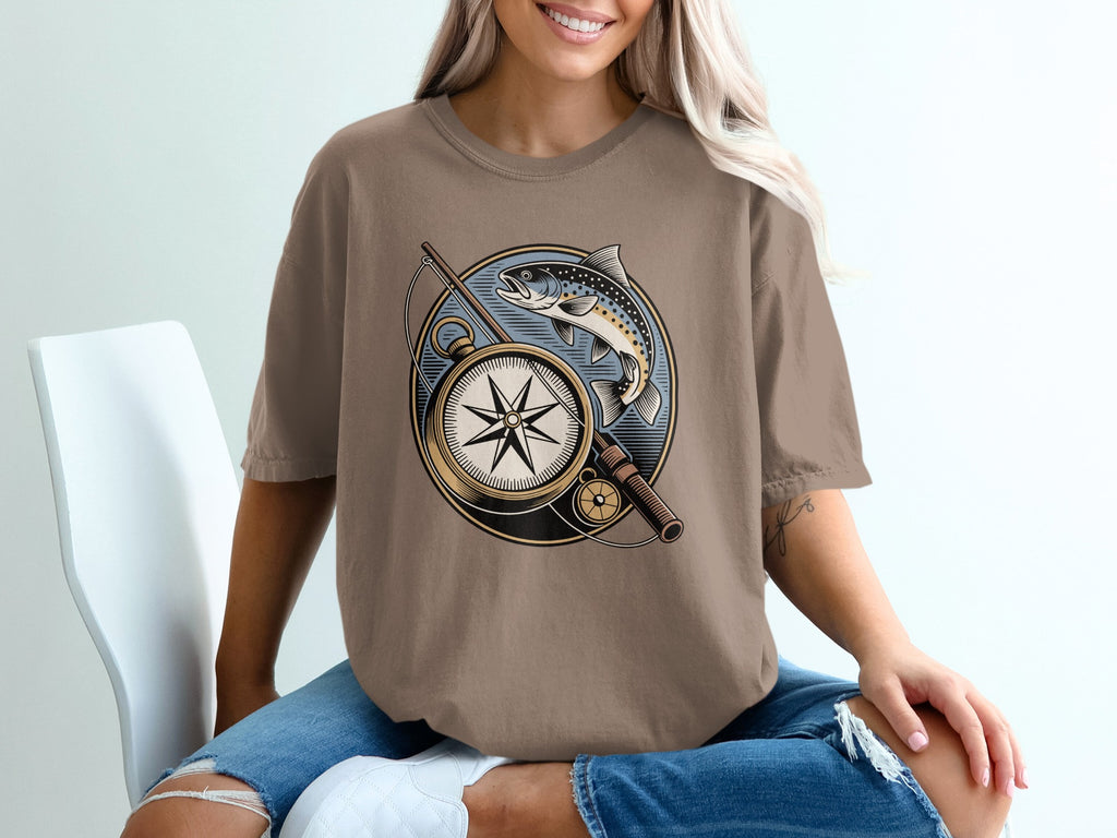T-shirt graphic with compass, fishing rod, and trout.