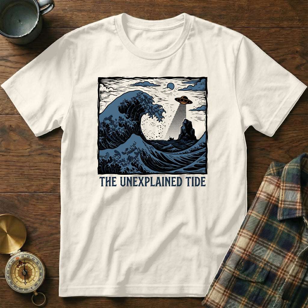 White t-shirt with "The Unexplained Tide" text and a wave with a UFO.