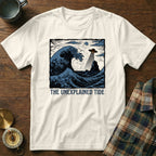White t-shirt with "The Unexplained Tide" text and a wave with a UFO.