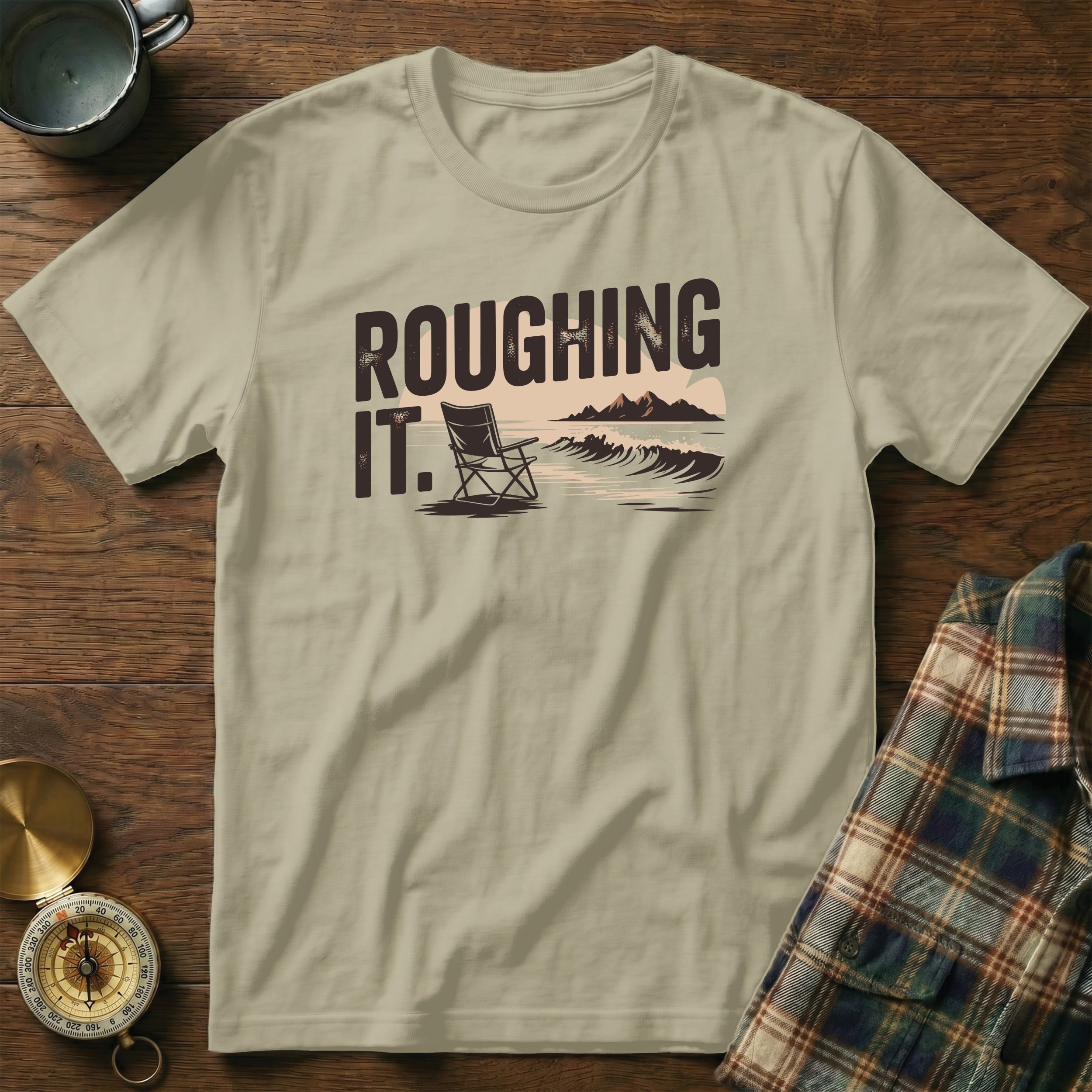 T-shirt with "ROUGHING IT." text, a beach chair, and waves graphic.