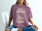 T-shirt with "Just Moved Again" text and a cartoon hermit crab.