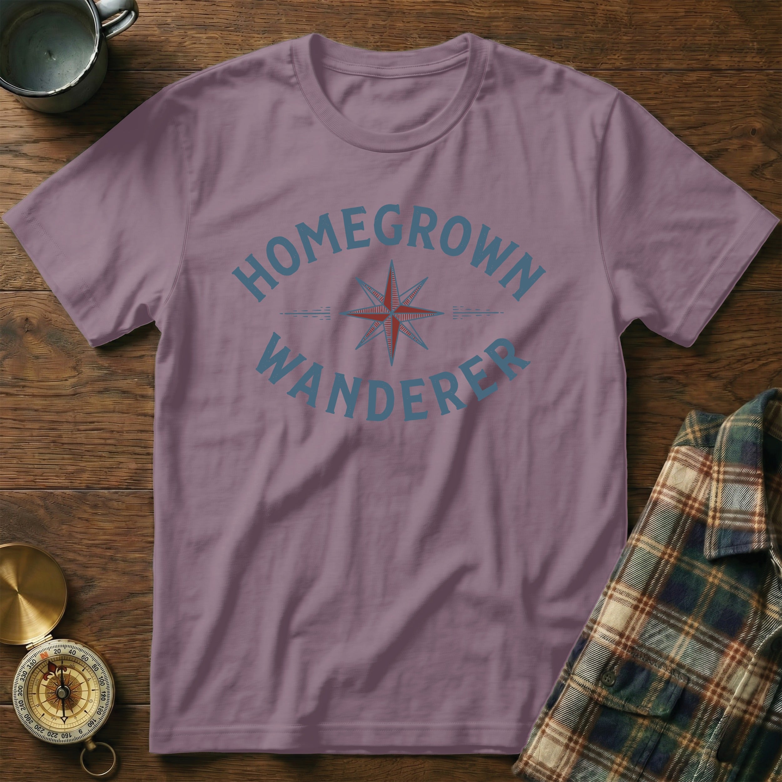 Purple t-shirt with "Homegrown Wanderer" text and compass graphic.