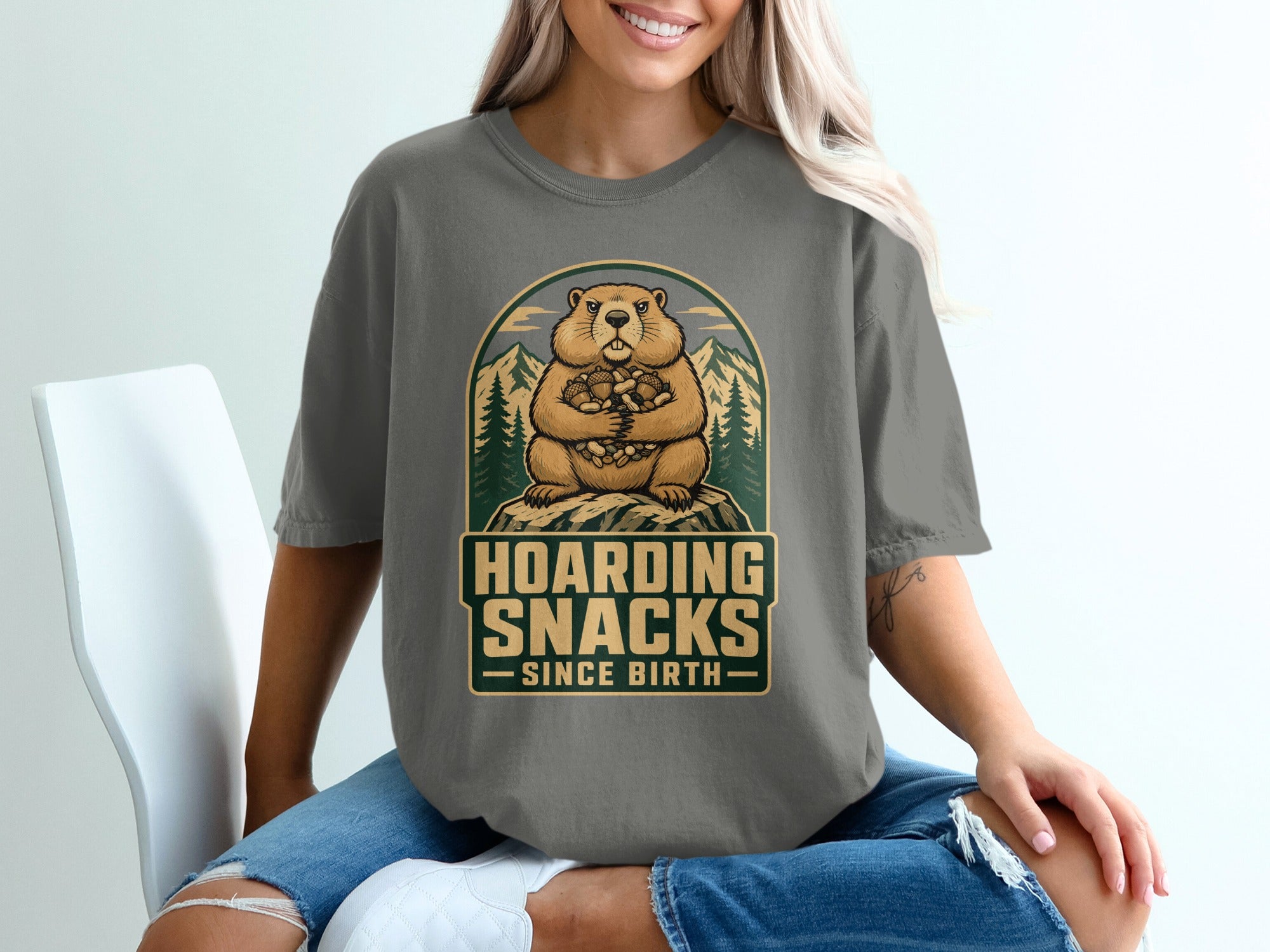 Groundhog holding nuts with text "Hoarding Snacks Since Birth".