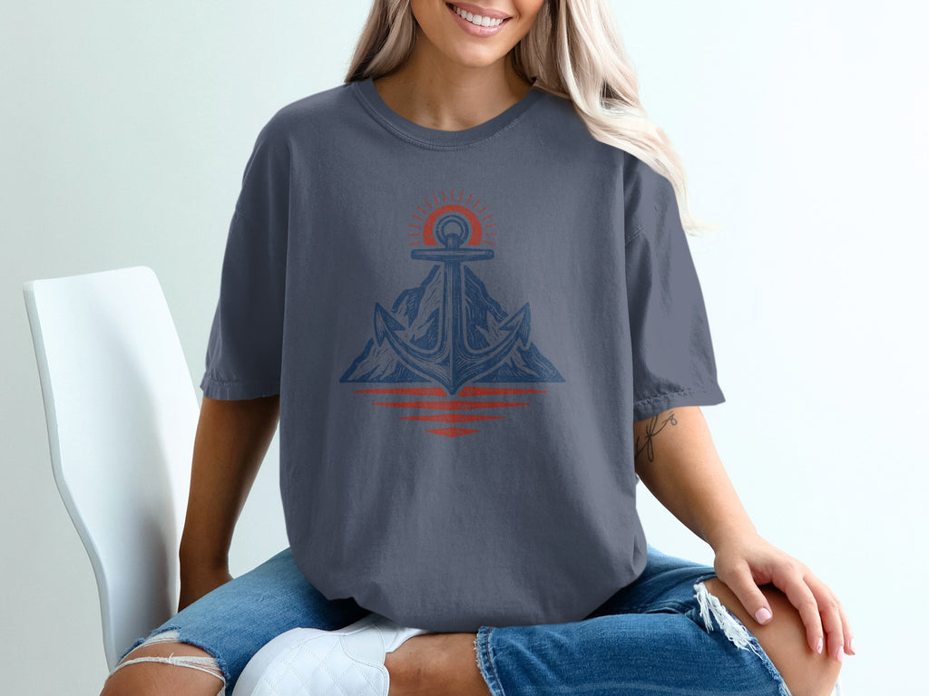 Anchor and mountain graphic with sunrise reflection on a dark blue t-shirt.