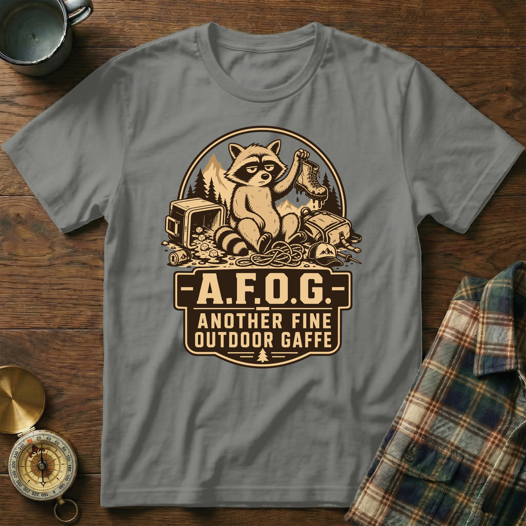 Gray t-shirt featuring a raccoon holding a boot and text "A.F.O.G. Another Fine Outdoor Gaffe".