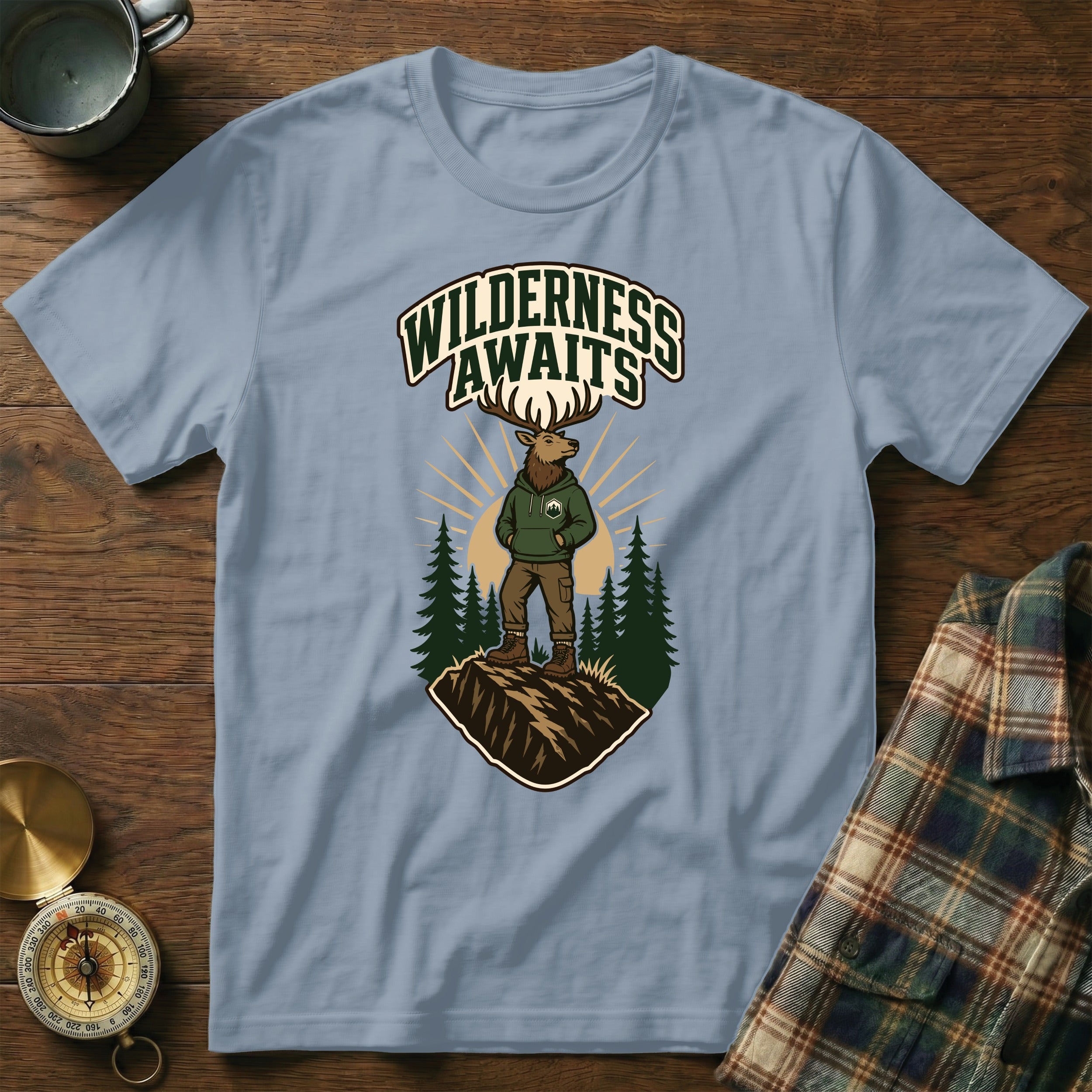Light blue t-shirt with elk graphic and "Wilderness Awaits" text.