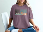 Purple t-shirt with "FROM SUMMIT TO SEA" text and mountain and ocean graphic.