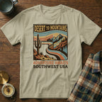 T-shirt with retro desert mountains landscape and text "Adventure Awaits Southwest USA".