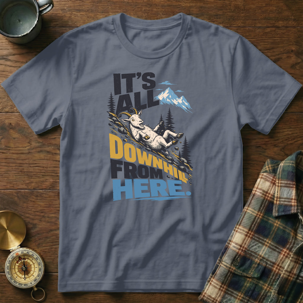 A slate gray t-shirt featuring a graphic of a goat sliding down a mountain with the text It's All Downhill From Here.