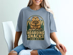 Groundhog design with text "Hoarding Snacks Since Birth" on a blue t-shirt.