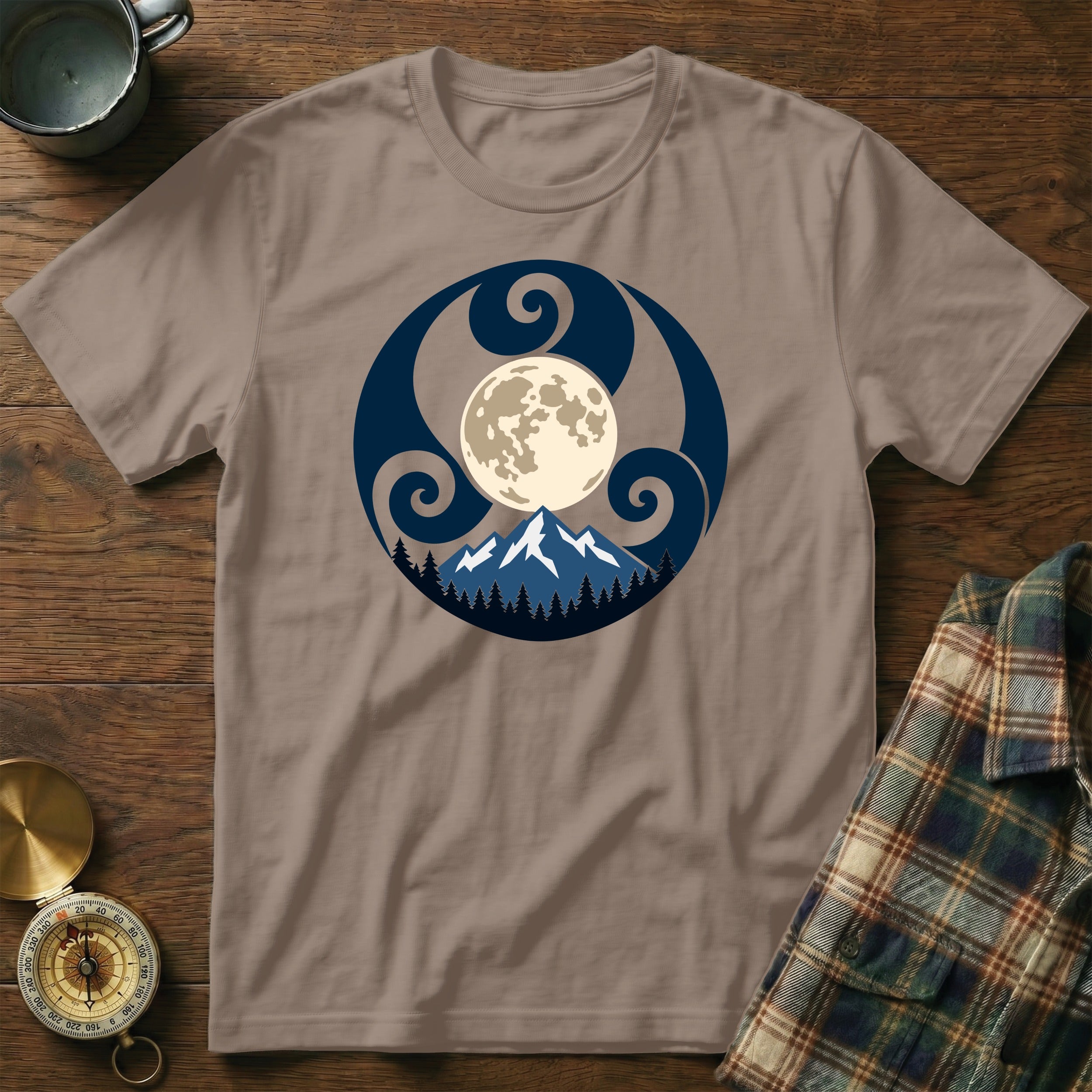 Taupe t-shirt with a circular nature design featuring a full moon over mountains and trees.