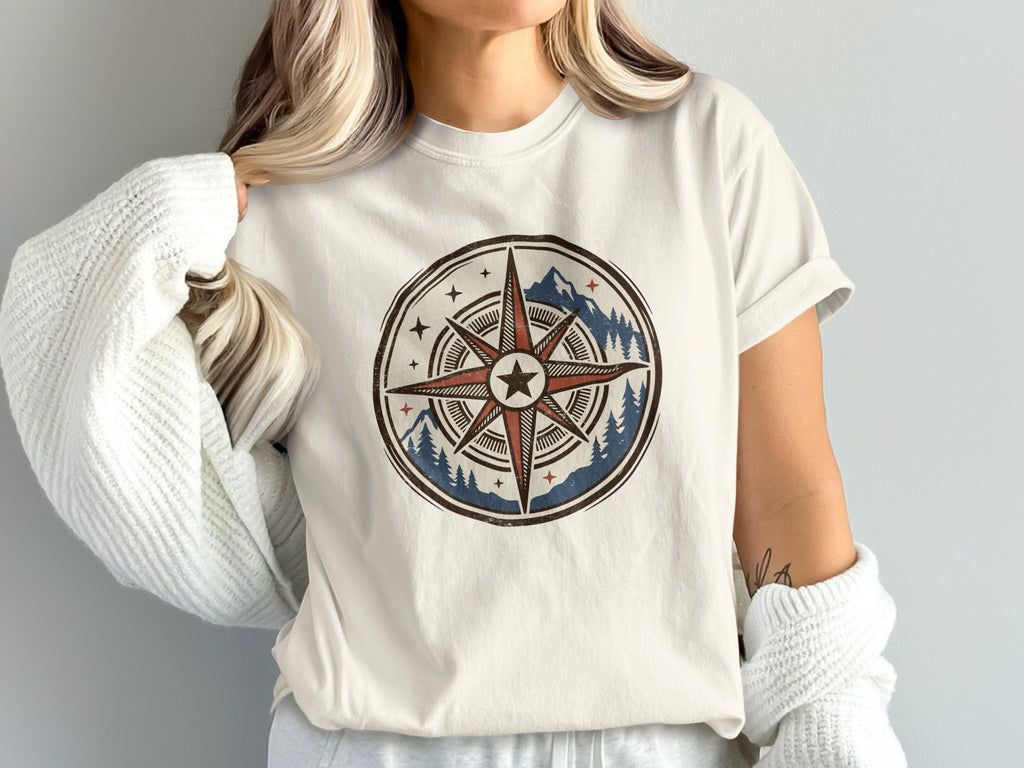 T-shirt with vintage compass graphic featuring mountains and pine trees.