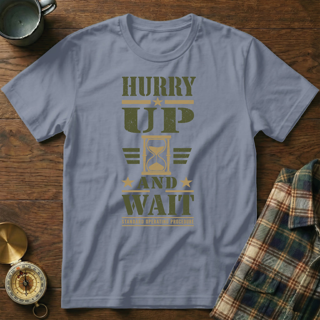Slate blue crewneck t-shirt featuring the green and gold text HURRY UP AND WAIT with an hourglass graphic.