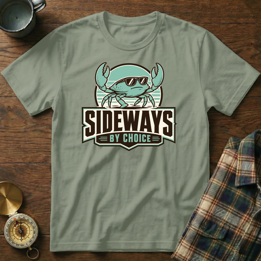 Sage green t-shirt with a cartoon crab wearing sunglasses and the text "SIDEWAYS BY CHOICE".