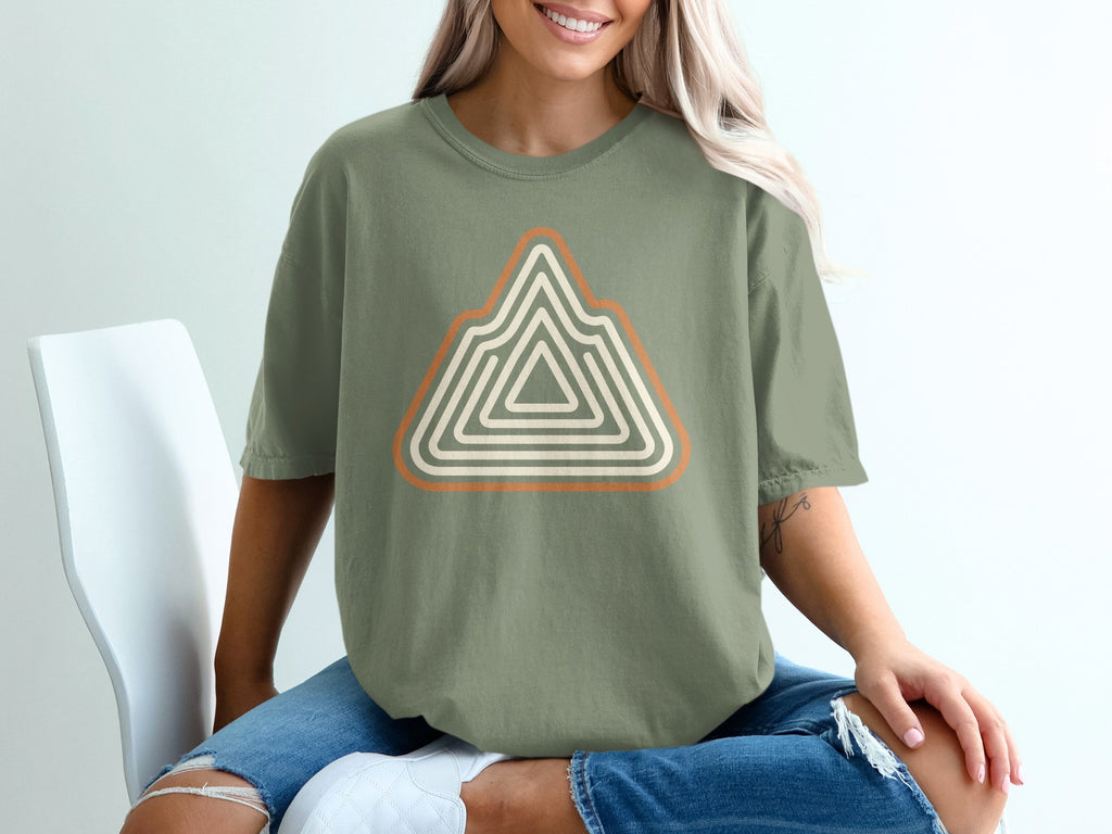 Green t-shirt with a stylized mountain logo in orange and cream stripes.