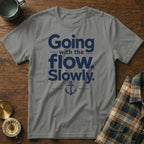 Gray t-shirt featuring blue text reading Going with the flow. Slowly. and a small anchor graphic.