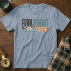 Light blue t-shirt with "FROM SUMMIT TO SEA" text and mountain and ocean graphic.