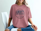 Rose t-shirt with circular graphic and mountains, text "LIBERTY LOOKS GOOD ON YOU".