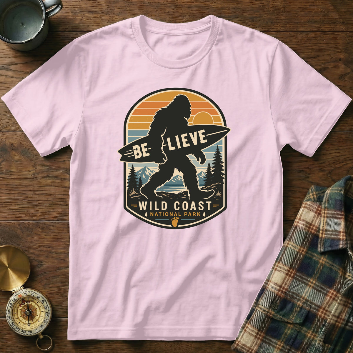 Pink t-shirt with Bigfoot graphic, "Be-lieve Wild Coast National Park".