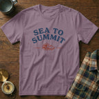 Purple t-shirt with "SEA TO SUMMIT" text and wave and mountain graphic.