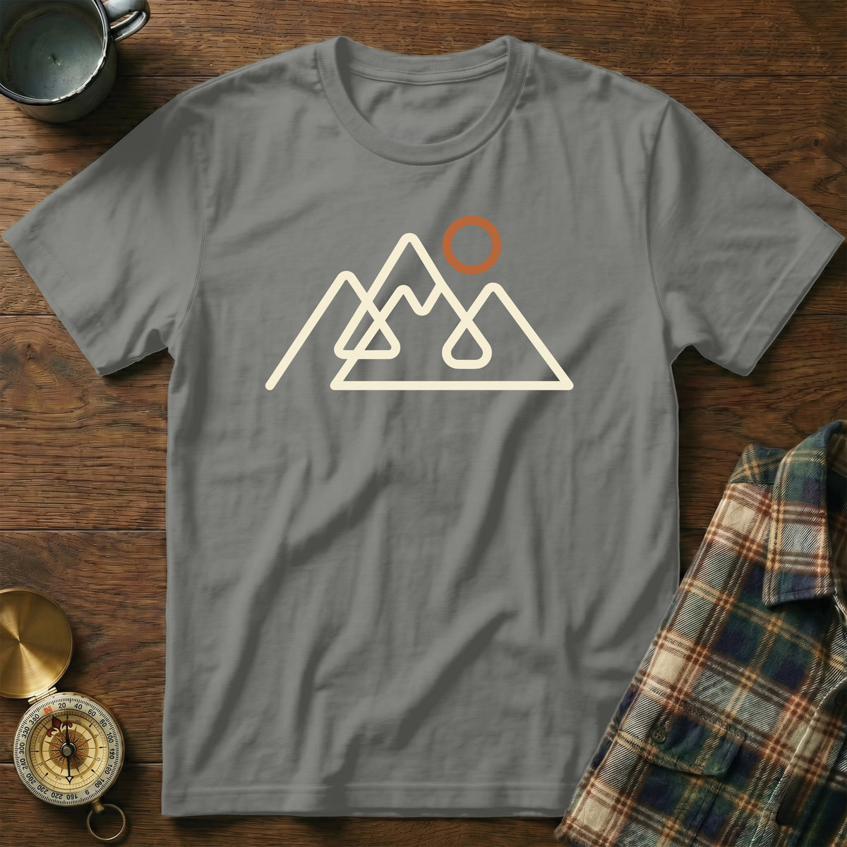 Grey t-shirt with a minimalist mountain range and sun graphic.