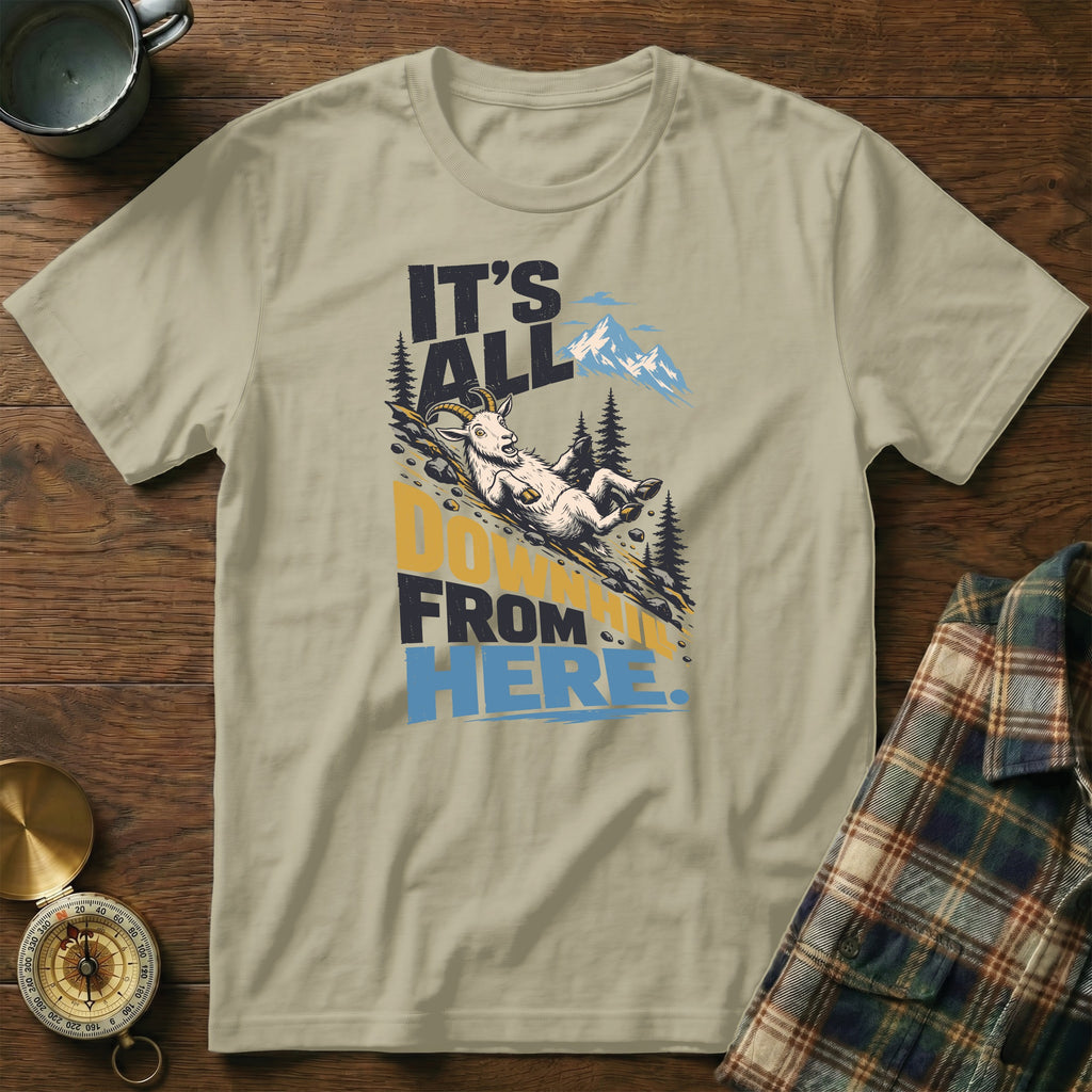 Olive green t-shirt featuring a graphic of a goat sliding down a mountain with the text It's All Downhill From Here.