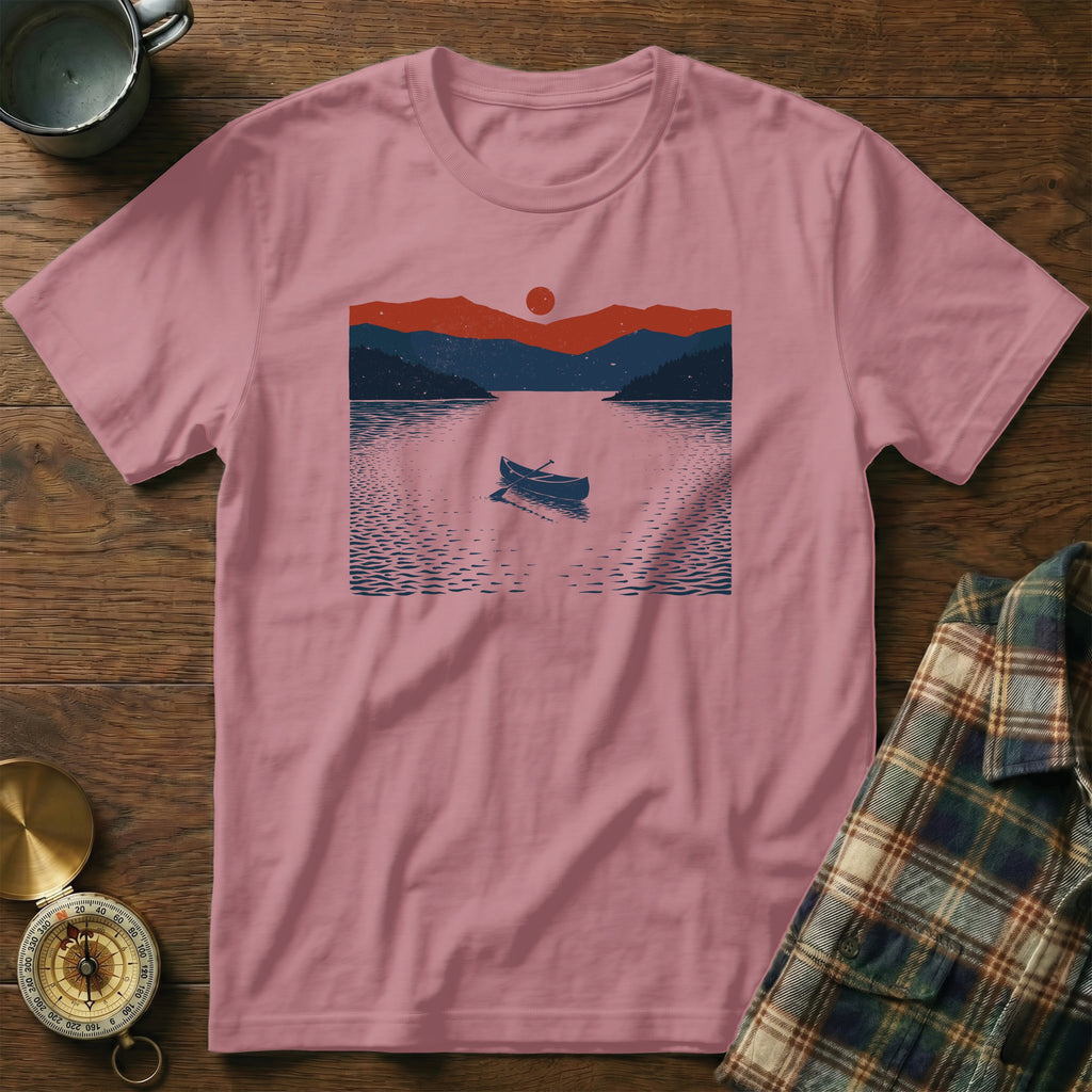 Pink t-shirt with a dark blue and red lake and mountain landscape graphic.