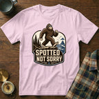 Pink t-shirt with Bigfoot graphic and text "SPOTTED NOT SORRY".