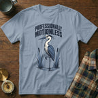 Light blue t-shirt with a heron and "PROFESSIONALLY MOTIONLESS" text.